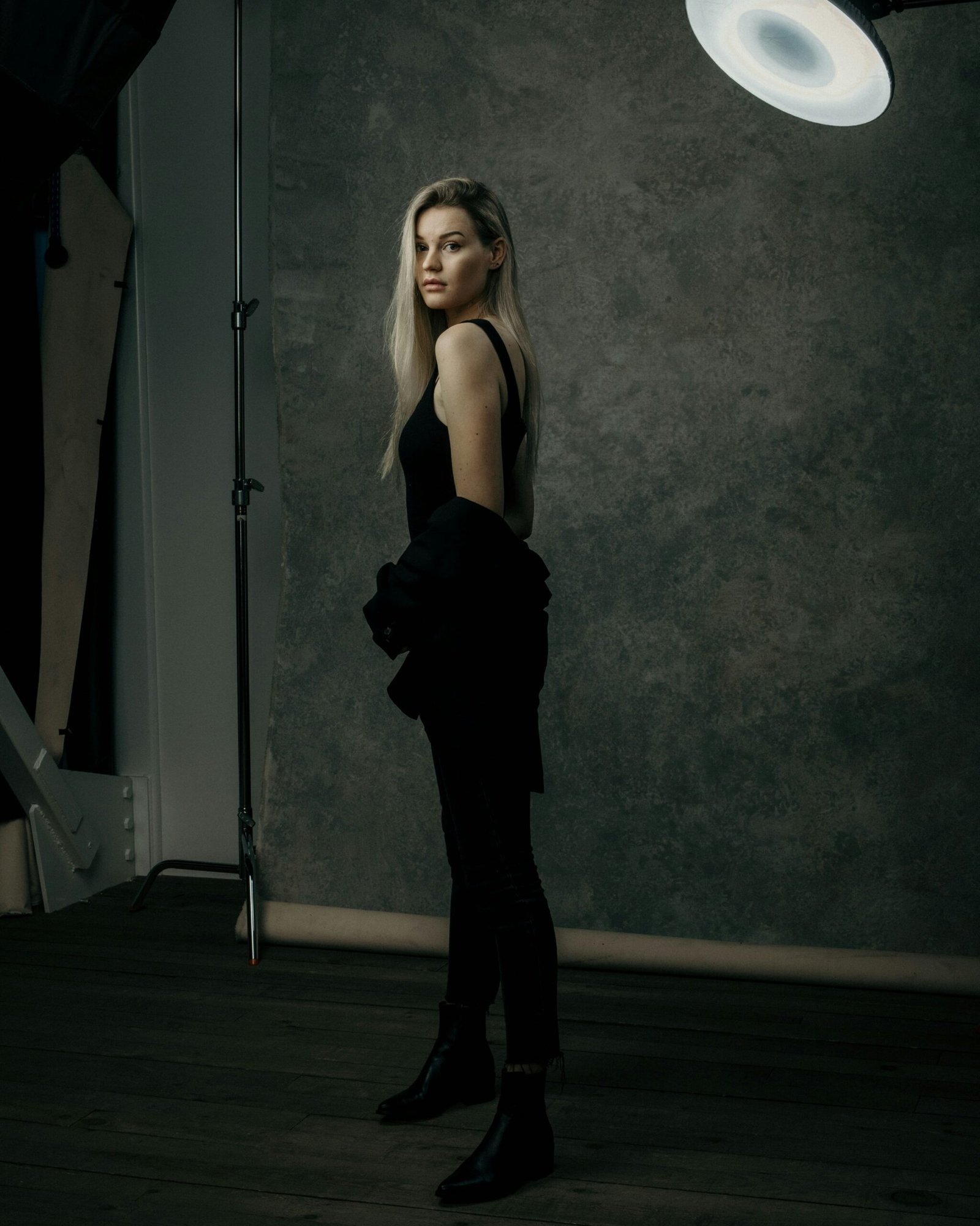 Camera on a tripod in front of a studio canvas setup